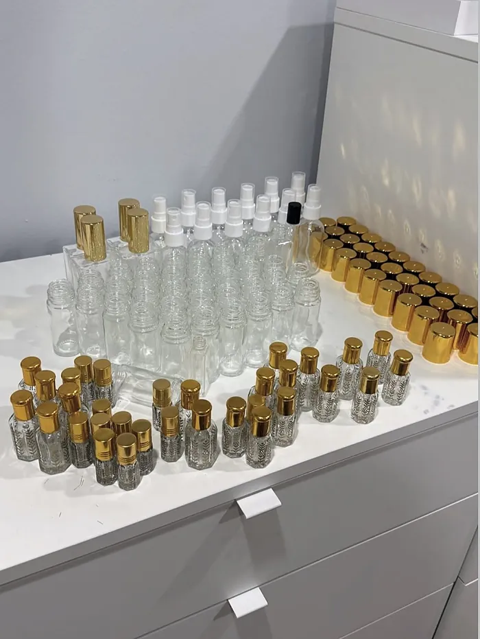 Rows of gold-capped bottles and spray bottles being prepared